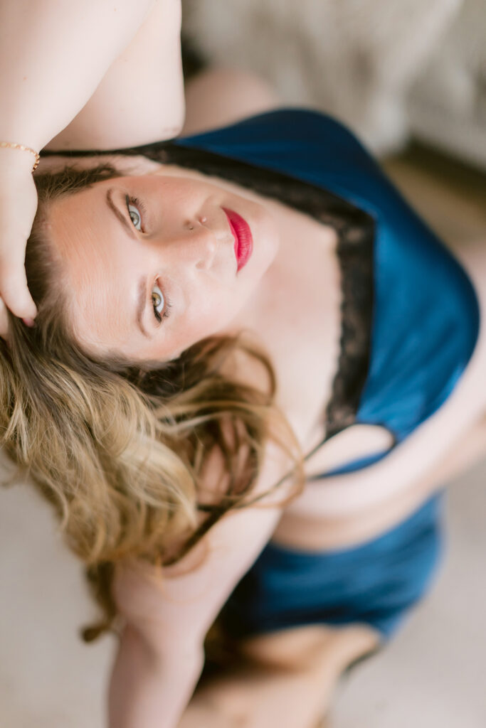 Woman in blue and black lingerie posing during a Sacramento boudoir photography session